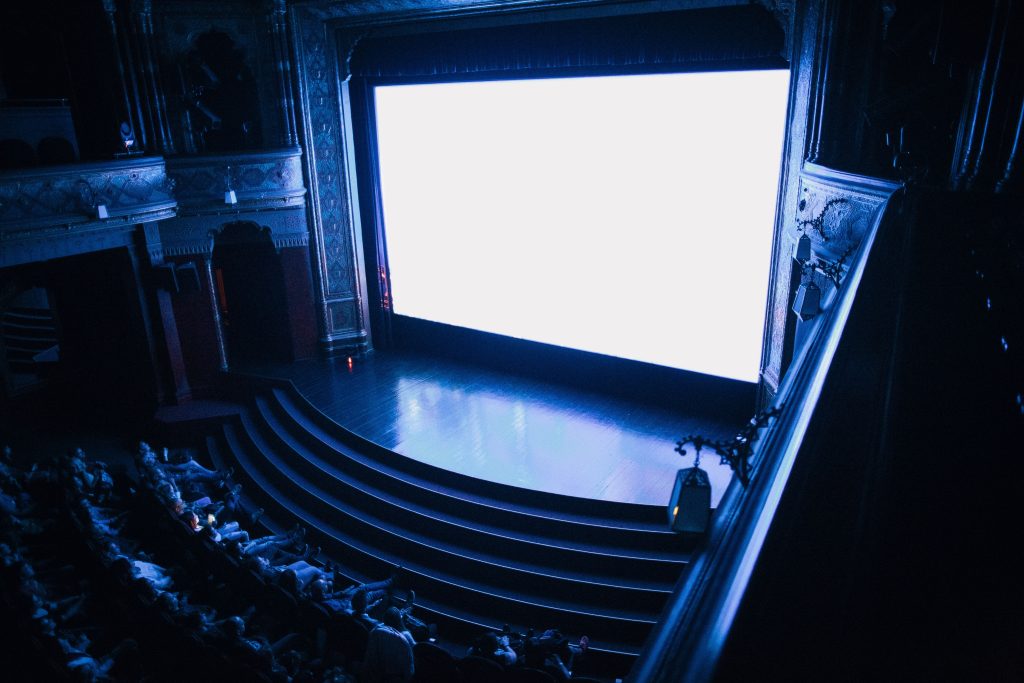 darkened theater with glowing screen